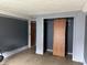 A bedroom with dark blue walls and a closet at 205 S 8Th St, Noblesville, IN 46060