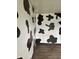 An unusual room with black and white cow print walls at 205 S 8Th St, Noblesville, IN 46060