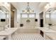 Bright bathroom features dual sinks, a soaking tub, and tile flooring at 2197 Duke Of York St, Carmel, IN 46032