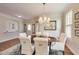 Elegant dining room with a round table, chandelier, plantation shutters, and neutral decor at 2197 Duke Of York St, Carmel, IN 46032
