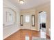 Bright foyer featuring hardwood floors, a decorative front door, and an arched entrance to another room at 2197 Duke Of York St, Carmel, IN 46032