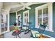 Charming front porch features rocking chairs, tables, and ceiling fan at 2197 Duke Of York St, Carmel, IN 46032