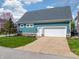 Detached two-car garage with a white door and a well-maintained driveway and lawn, matching the home's exterior at 2197 Duke Of York St, Carmel, IN 46032