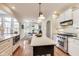 Well-lit kitchen with stainless steel appliances, center island, and hardwood floors. Connects to breakfast area at 2197 Duke Of York St, Carmel, IN 46032