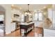 Charming kitchen with white cabinetry, stainless steel appliances, center island and hardwood floors at 2197 Duke Of York St, Carmel, IN 46032