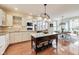 Open kitchen featuring a center island, modern appliances, and hardwood floors, open to the breakfast nook at 2197 Duke Of York St, Carmel, IN 46032