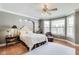 Spacious main bedroom features hardwood floors, accent lighting, and a cozy seating area at 2197 Duke Of York St, Carmel, IN 46032