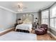 Serene main bedroom boasts hardwood floors, soft lighting, and comfortable seating; perfect for relaxation at 2197 Duke Of York St, Carmel, IN 46032