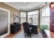 Bright office space featuring a desk, plantation shutters, wood floors, and tasteful decor at 2197 Duke Of York St, Carmel, IN 46032