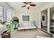 Relaxing sunroom featuring hardwood floors, large windows, and cozy seating; ideal for leisure at 2197 Duke Of York St, Carmel, IN 46032