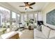 Inviting sunroom with abundant natural light, comfortable seating, and access to outdoor living space at 2197 Duke Of York St, Carmel, IN 46032