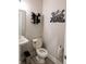 Half bath featuring a pedestal sink and toilet with decorative accents at 2280 Meadow Crk, Avon, IN 46123