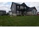 Eye-level view of a gray stone and siding home with professional landscaping at 2280 Meadow Crk, Avon, IN 46123