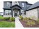 Close-up of the entryway and front door with stone accents and professional landscaping at 2280 Meadow Crk, Avon, IN 46123