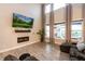 Living room featuring fireplace, high ceilings, and large windows with neighborhood views and exterior living at 2280 Meadow Crk, Avon, IN 46123
