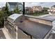 Outdoor kitchen featuring a built-in grill and ample counter space, ideal for summer entertaining and dining at 2280 Meadow Crk, Avon, IN 46123