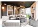Covered patio with comfortable outdoor seating and a decorative fireplace at 2280 Meadow Crk, Avon, IN 46123