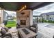 Outdoor patio featuring a brick fireplace, comfortable seating, and a view of the backyard at 2280 Meadow Crk, Avon, IN 46123