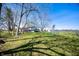Backyard featuring grass, mature trees, chainlink fence and a playset at 2372 S 300 E, Anderson, IN 46017