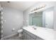 Bathroom with gray walls, tile flooring, single sink vanity and large framed mirror at 2372 S 300 E, Anderson, IN 46017