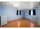 Bedroom featuring wood floors, blue walls, and a crib at 2372 S 300 E, Anderson, IN 46017