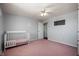 Bedroom featuring pink carpet, white walls, white trim, and ceiling fan with light fixture at 2372 S 300 E, Anderson, IN 46017