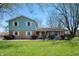 Inviting two-story home featuring a well-maintained lawn and a charming front porch, perfect for relaxing outdoors at 2372 S 300 E, Anderson, IN 46017