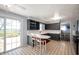 Bright kitchen featuring white countertops, gray cabinets, and a breakfast bar with seating, perfect for casual dining at 2372 S 300 E, Anderson, IN 46017
