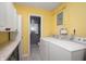 Laundry room featuring tile flooring, yellow walls and washer and dryer hookups at 2372 S 300 E, Anderson, IN 46017