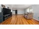Comfortable living room featuring hardwood floors, a cozy recliner, and plenty of space for entertaining at 2372 S 300 E, Anderson, IN 46017