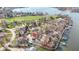 A picturesque aerial view of a lakeside property with neighboring houses, showcasing waterfront living and scenic views at 2469 Cape Henry Ct, Cicero, IN 46034