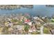 An aerial view of a lakefront neighborhood with mature trees surrounding cozy houses and a tranquil lake at 2469 Cape Henry Ct, Cicero, IN 46034