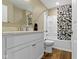 Clean bathroom features a vanity with sink, toilet, and shower/tub combination with a floral shower curtain at 2469 Cape Henry Ct, Cicero, IN 46034