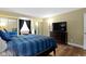 Bedroom includes mirrored closet doors, a large TV, and a cozy reading corner at 2469 Cape Henry Ct, Cicero, IN 46034