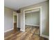 Bedroom with sliding mirror closet doors, vinyl floor, baseboard trim, and neutral paint for a comfortable retreat at 2469 Cape Henry Ct, Cicero, IN 46034