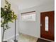 Cozy entryway with tiled floors, white walls, and a wooden front door at 2469 Cape Henry Ct, Cicero, IN 46034