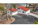 Aerial view of a white home with a red roof, an attached garage, and a spacious paved driveway at 2469 Cape Henry Ct, Cicero, IN 46034