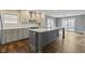 Modern kitchen with island seating and view to both the dining and living spaces at 2469 Cape Henry Ct, Cicero, IN 46034