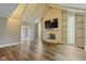 Inviting living room with hardwood floors, fireplace, shelving, stained glass windows, and vaulted ceilings at 2469 Cape Henry Ct, Cicero, IN 46034