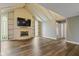 Bright living room with vaulted ceilings, hardwood floors, and built-in shelves surrounding a fireplace at 2469 Cape Henry Ct, Cicero, IN 46034