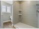Shower stall features tiled walls, decorative window, built-in corner shelves, and chrome showerhead at 2469 Cape Henry Ct, Cicero, IN 46034