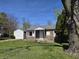 Charming single-story home with stone exterior and a well-manicured front yard at 2950 Denison St, Indianapolis, IN 46241