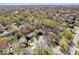 High aerial showcasing the property's setting amongst lush, mature trees and neighboring homes at 315 Heritage Ct, Fishers, IN 46038