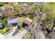 Aerial view of a home with a grey roof, trees, and some nearby residential buildings at 315 Heritage Ct, Fishers, IN 46038