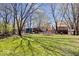 Lush green backyard featuring mature trees, a playset, and a storage shed at 315 Heritage Ct, Fishers, IN 46038