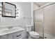 Bright bathroom features a vanity with Hollywood-style mirror and a tiled shower with sliding glass doors at 315 Heritage Ct, Fishers, IN 46038