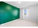 Bright bedroom with neutral carpet, gray walls and one accent wall painted in green at 315 Heritage Ct, Fishers, IN 46038