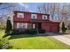 Charming two-story home featuring a two-car garage, brick and wood siding, and a well-maintained front lawn at 315 Heritage Ct, Fishers, IN 46038