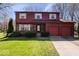 Charming two-story home featuring a two-car garage, brick and wood siding, and a well-maintained front lawn at 315 Heritage Ct, Fishers, IN 46038