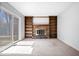 Inviting living room with a brick fireplace, custom built-ins, and a sliding glass door to the outside at 315 Heritage Ct, Fishers, IN 46038